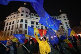 People wave Romanian and European Union flags during a pro-EU rally