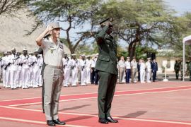 Senegal&#039;s chief of the general staff, General Mbaye Cisse, right, and French General Pascal Ianni, who commands France&#039;s troops in Africa, salute as the Senegalese flag is raised during a ceremony to return Camp Geille, France&#039;s largest base in the country, and its airfield at Dakar&#039;s airport to Senegal [Patrick Meinhardt/AFP]