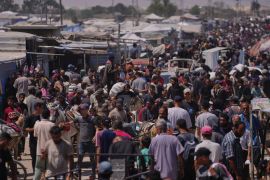 Palestinians carry bags containing food and humanitarian aid packages delivered by the Gaza Humanitarian Foundation, a U.S.-backed organization, in Rafah, southern Gaza Strip, Wednesday, June 25, 2025. (AP Photo/Abdel Kareem Hana)